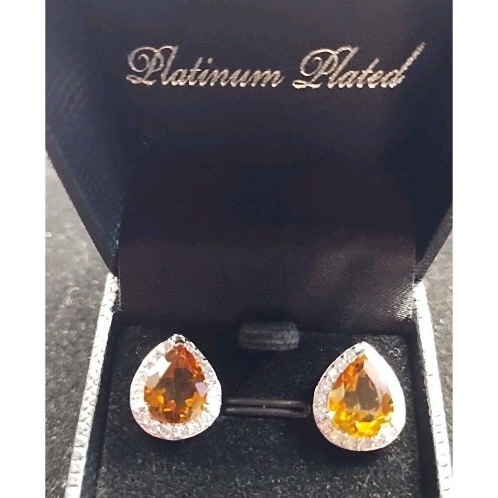 pear-shaped citrine earrings feature a halo of accent stones set in a platinum-p